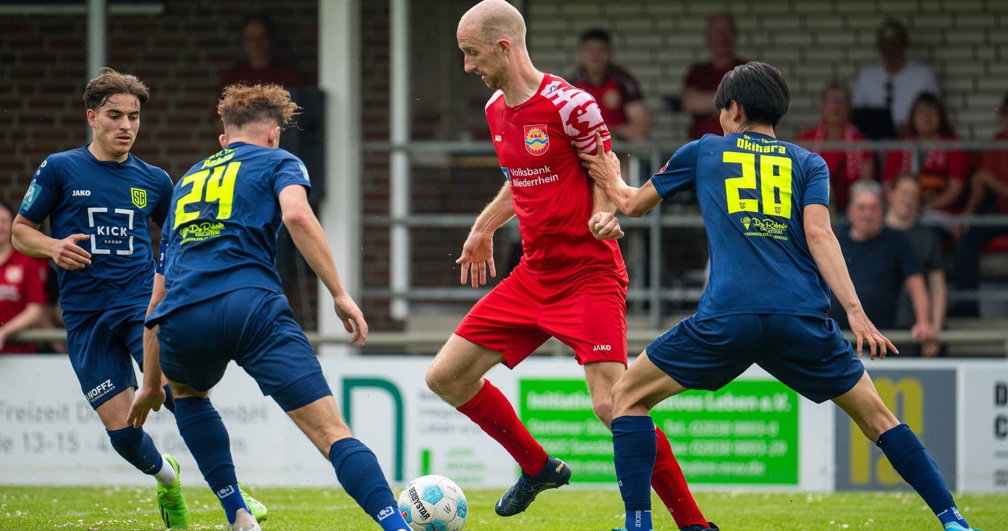 Player dribbling past opponents in football match