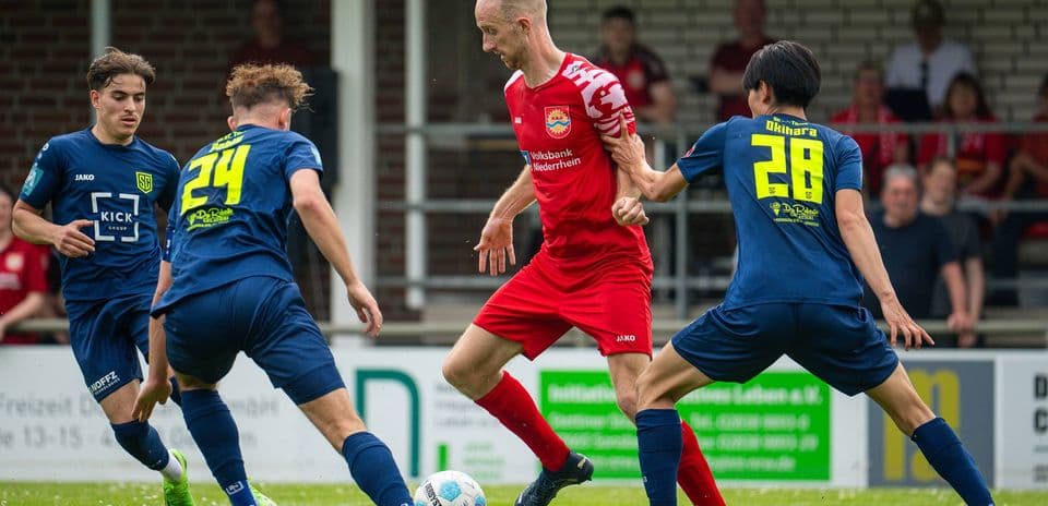 Player dribbling past opponents in football match