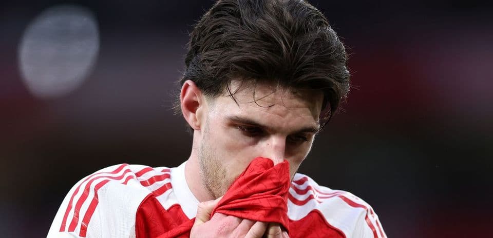 Player holding jersey to face after match