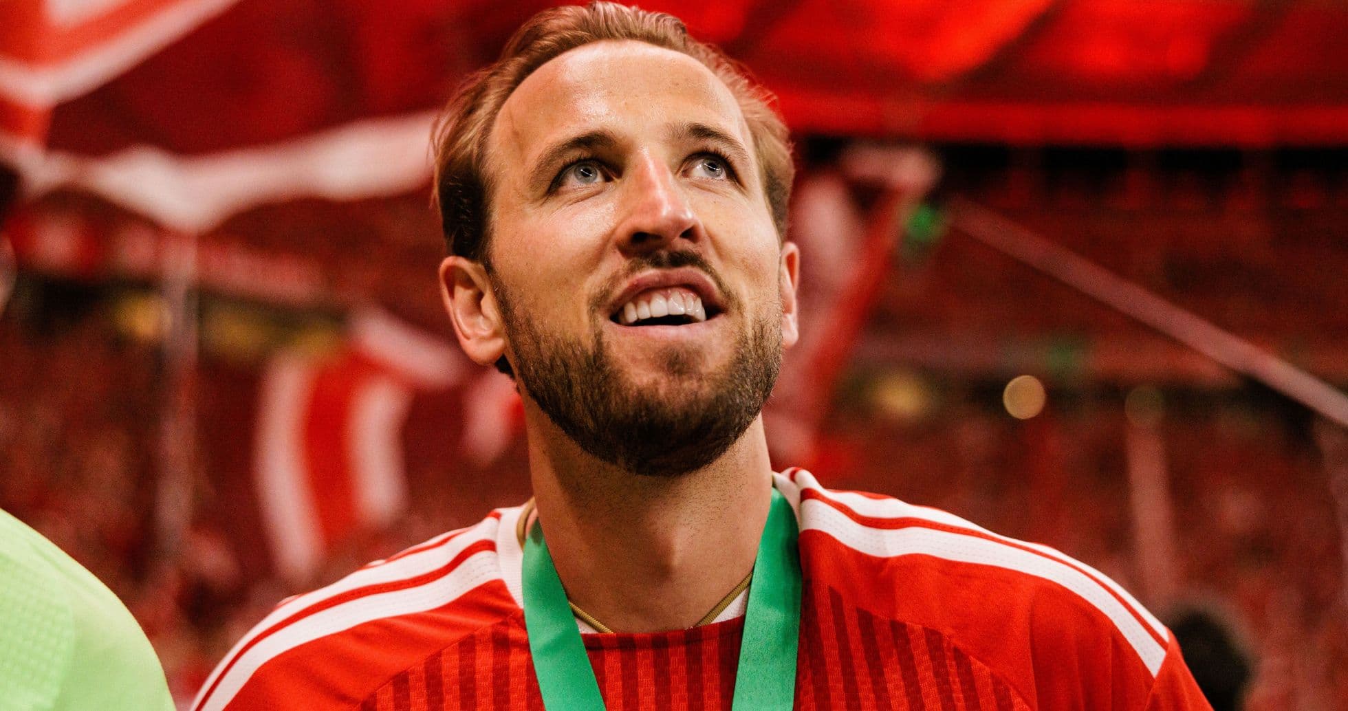Player celebrating with medal in stadium