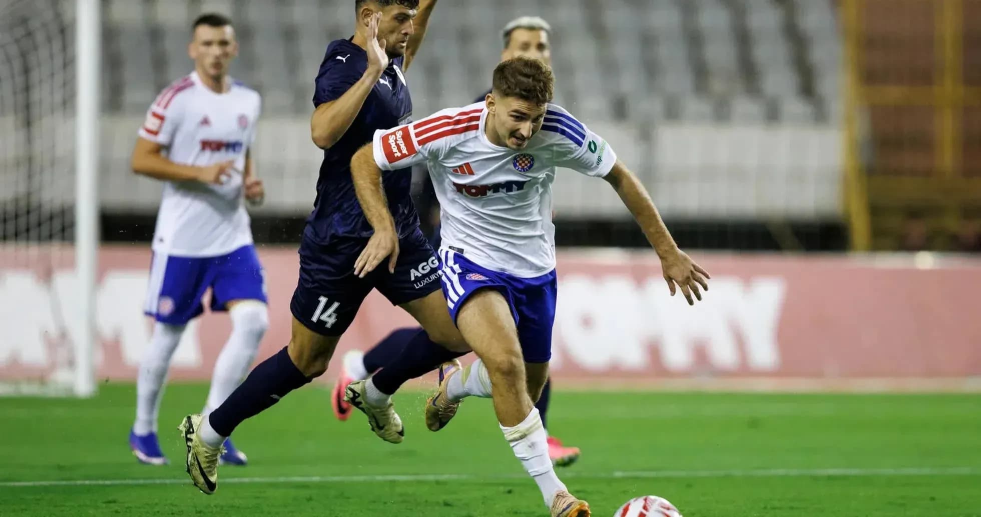 Pafos player tackling HNK Hajduk Split player