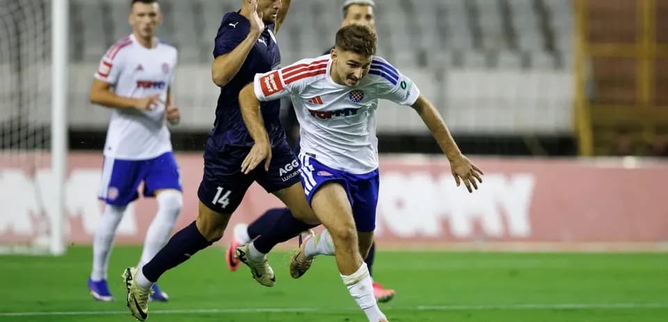 Pafos player tackling HNK Hajduk Split player