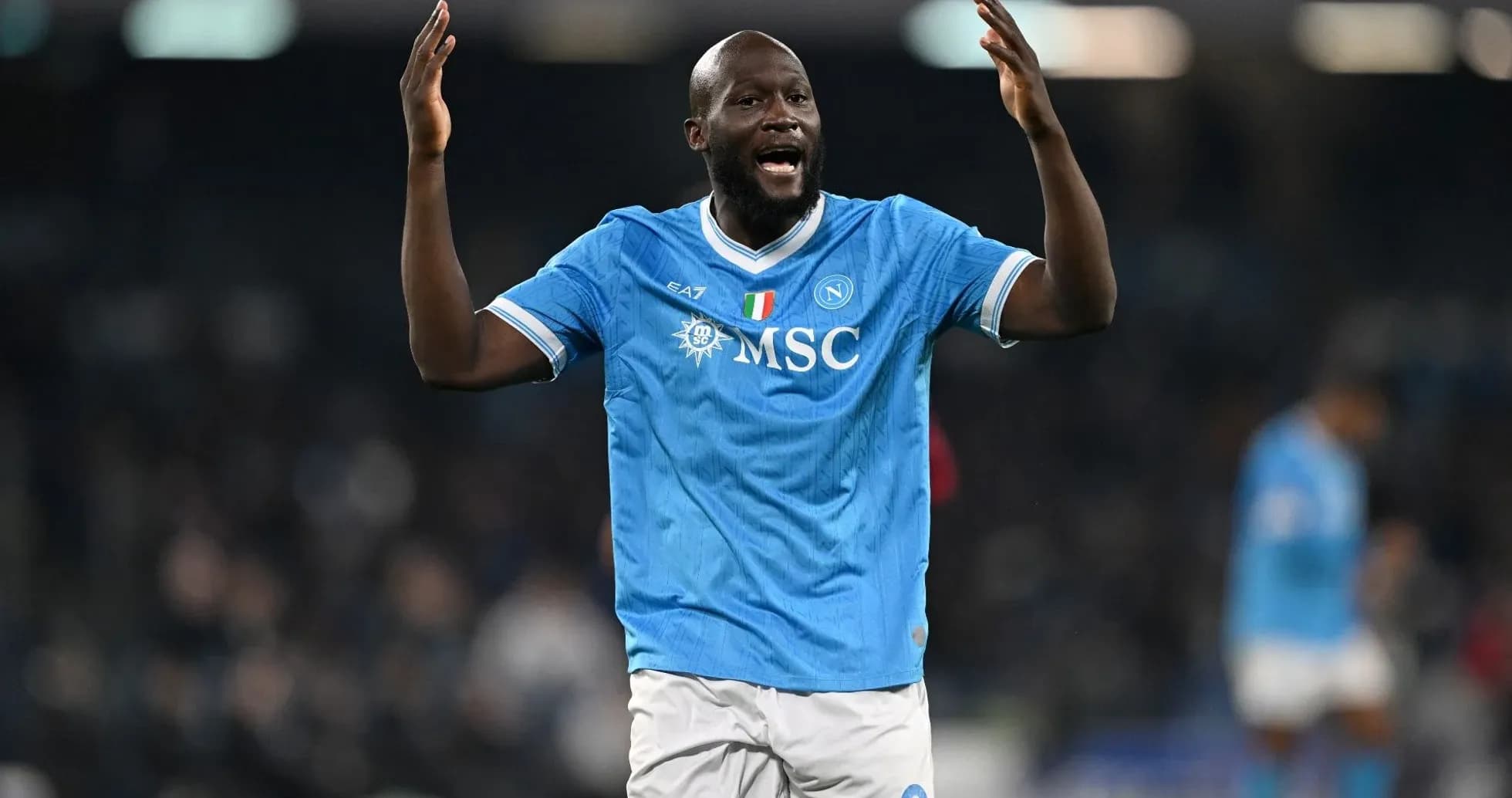 Player celebrating in Napoli's blue home jersey