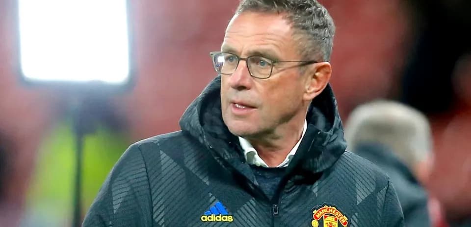 Manager in Manchester United jacket on sidelines
