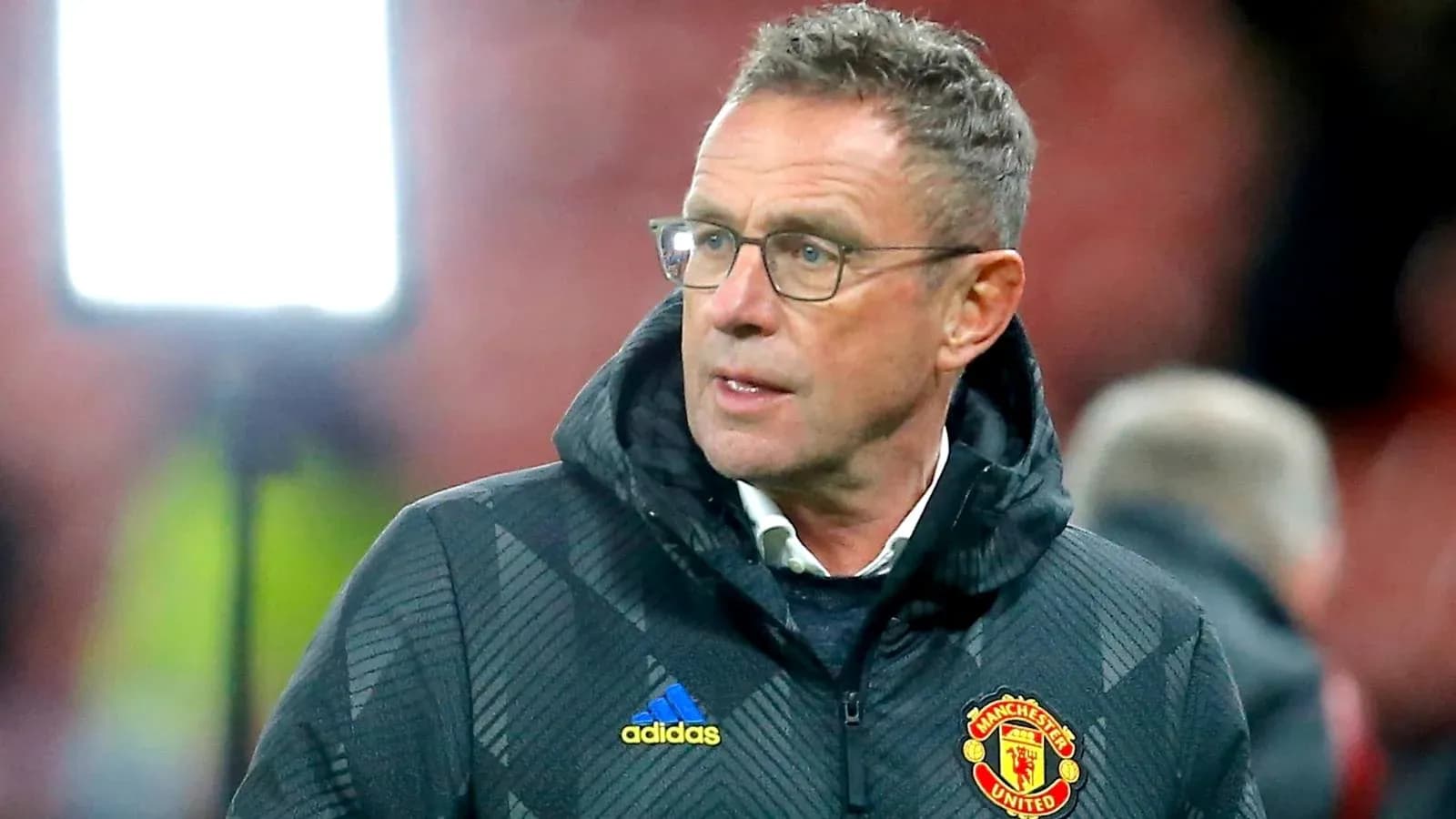 Manager in Manchester United jacket on sidelines