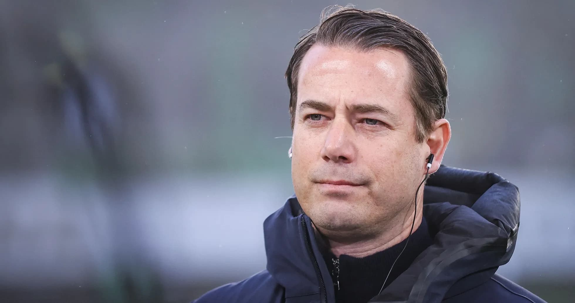 Coach wearing earphones during match preparation