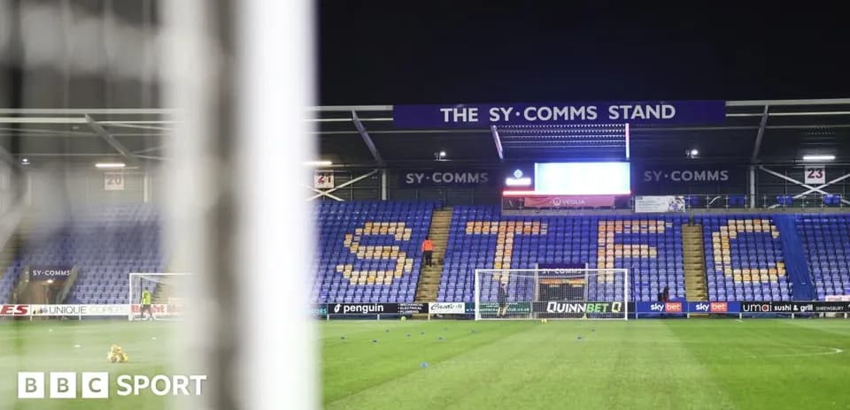 Empty football stadium with 'STFC' displayed on seats