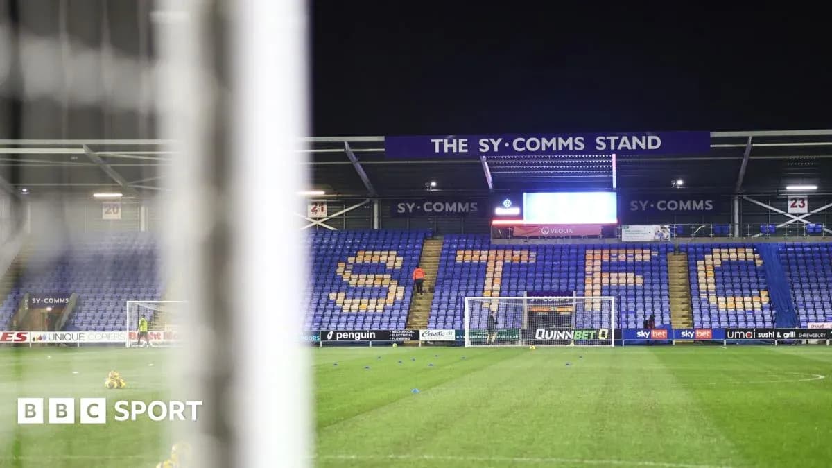 Empty football stadium with 'STFC' displayed on seats