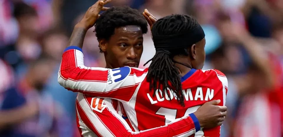 Two players celebrating a goal on the field