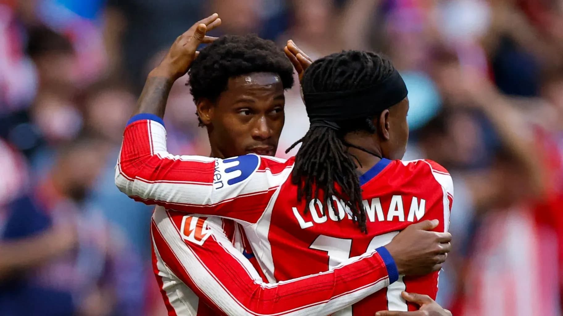 Two players celebrating a goal on the field