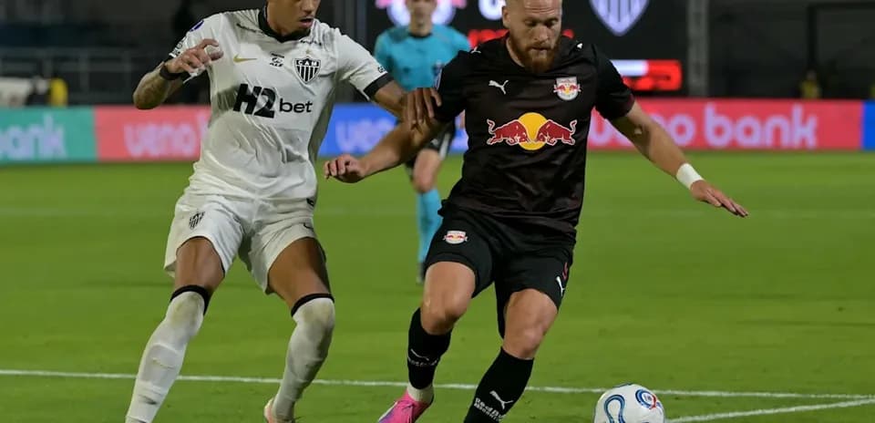 Two players competing for the ball in football match