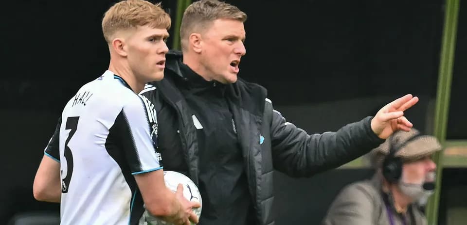 Manager giving instructions to player on sidelines