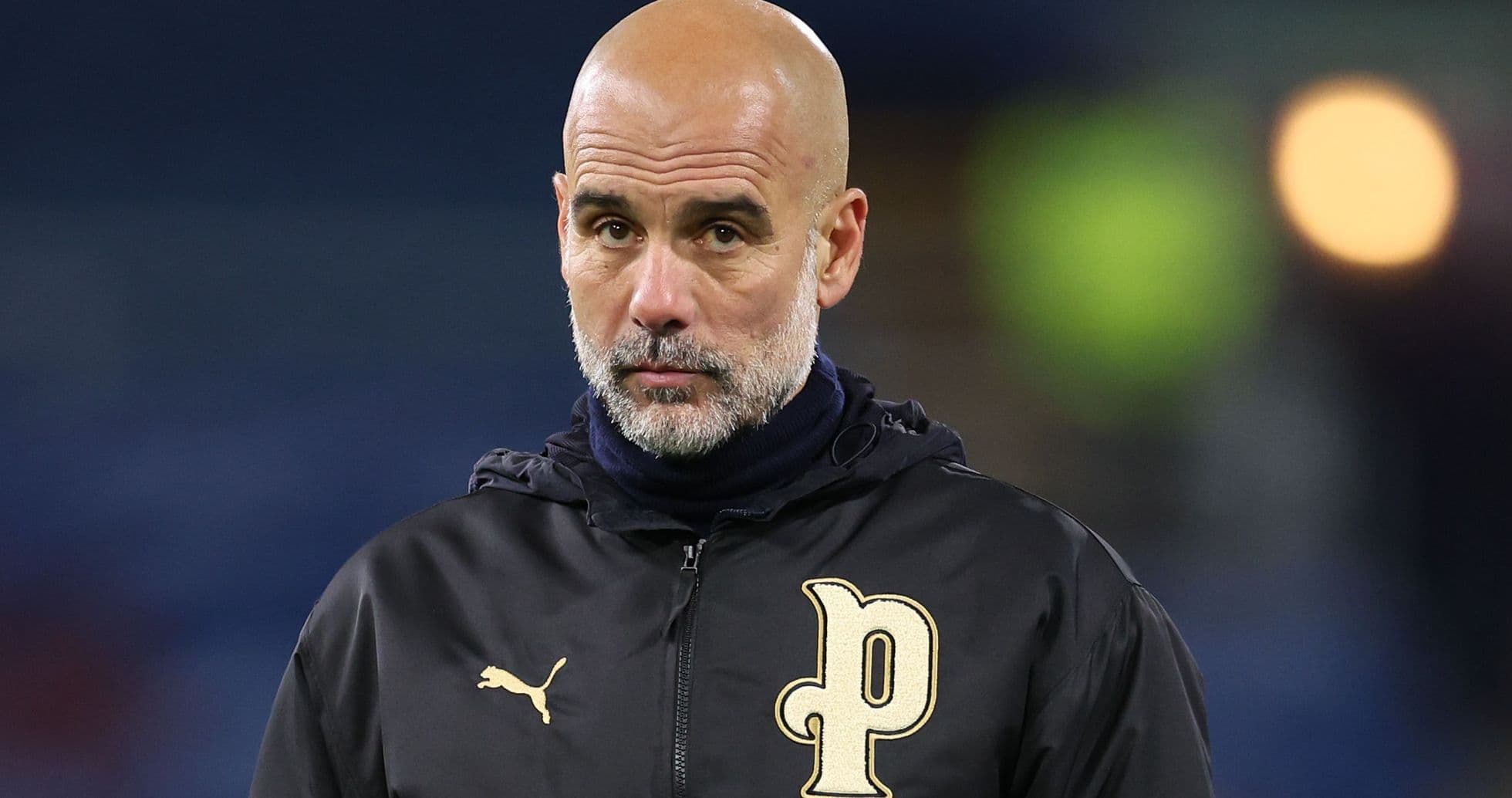 Coach in black jacket during match preparation