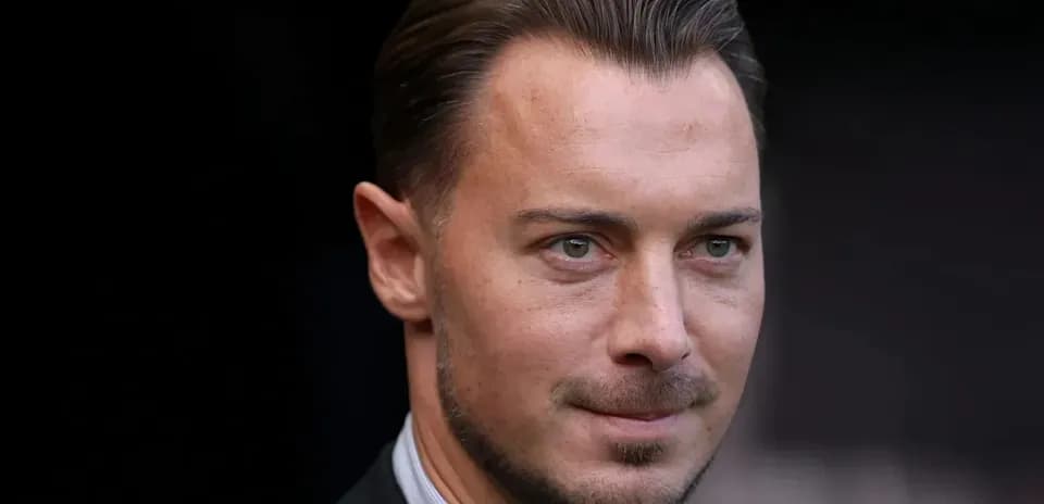 Man in suit looking towards the camera