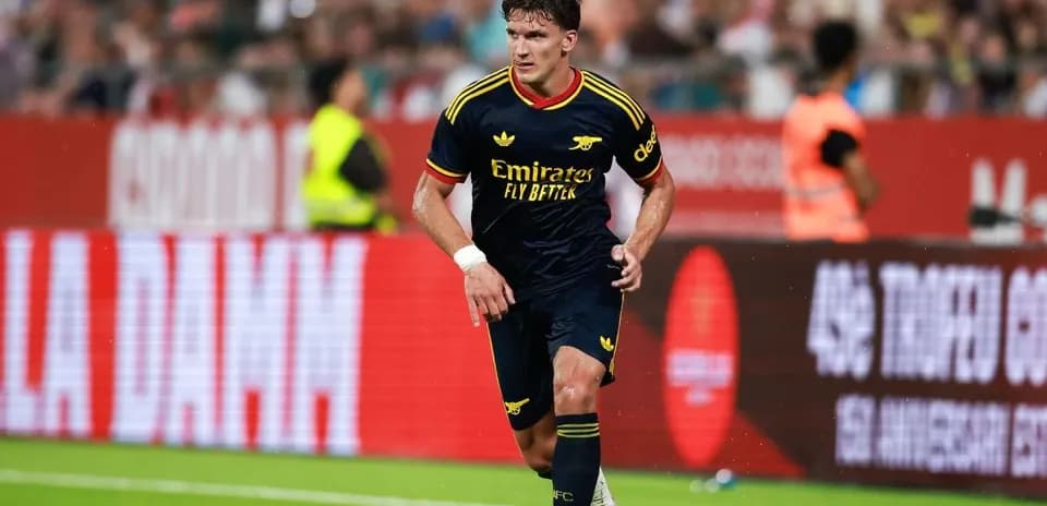 Player dribbling ball during match in Arsenal kit