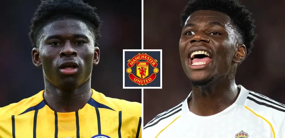 Two football players with Manchester United logo between them