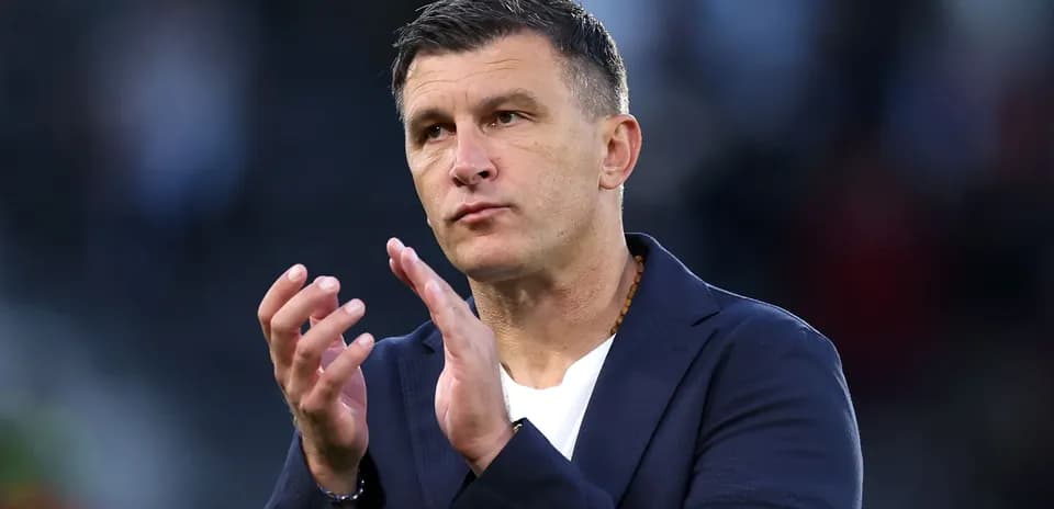 Coach applauding during post-match presentation