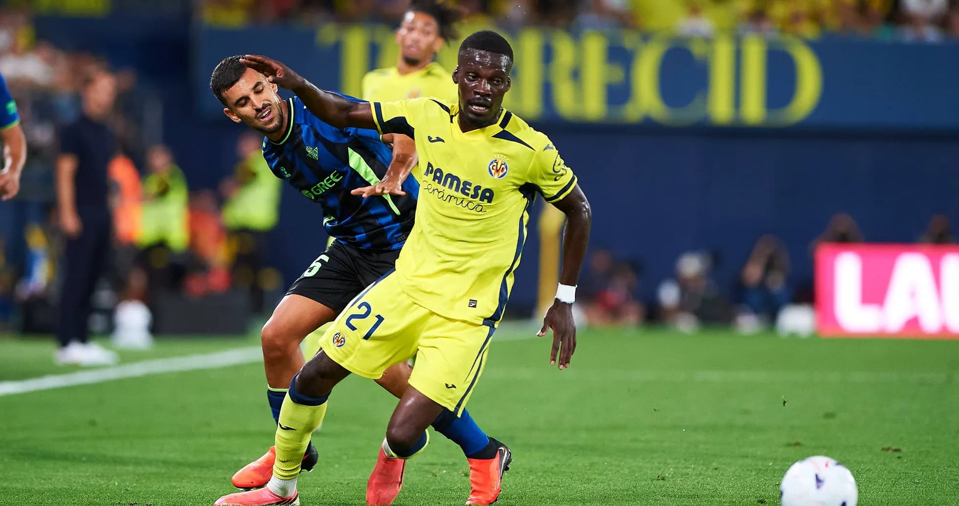 Villarreal player dribbling past defender during match