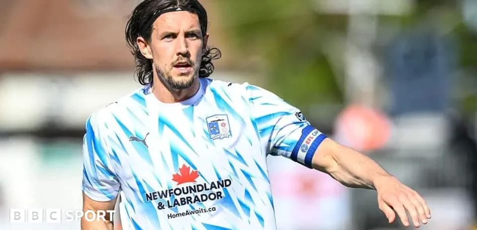 Player in blue and white jersey on field