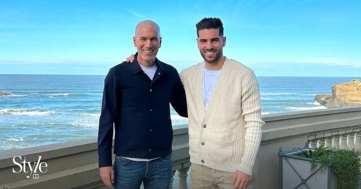 Two men posing together with ocean background