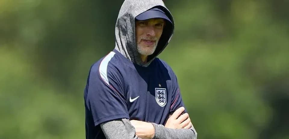 Coach observing training session in hoodie