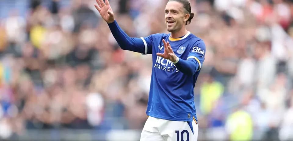 Player in blue jersey gesturing to crowd