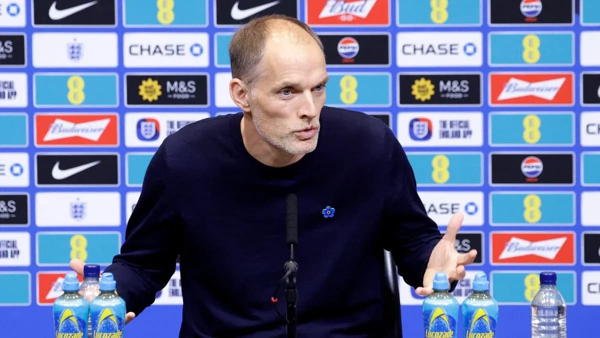 Manager speaking at press conference with water bottles
