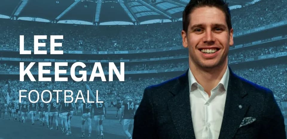Lee Keegan smiling with stadium crowd in background