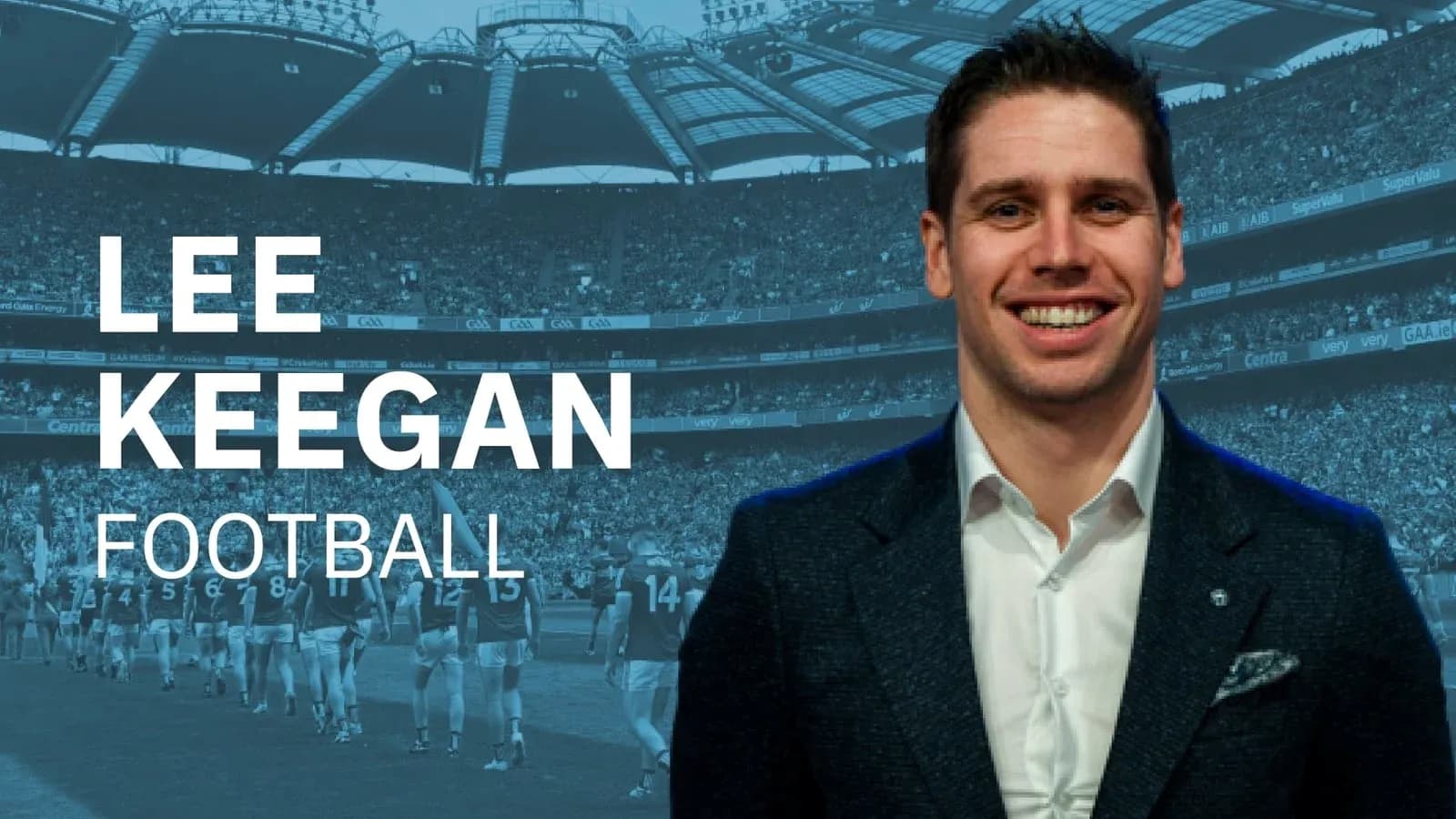 Lee Keegan smiling with stadium crowd in background