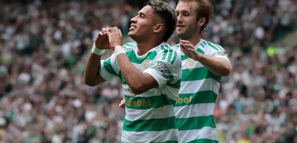Celtic players celebrating a goal in stadium