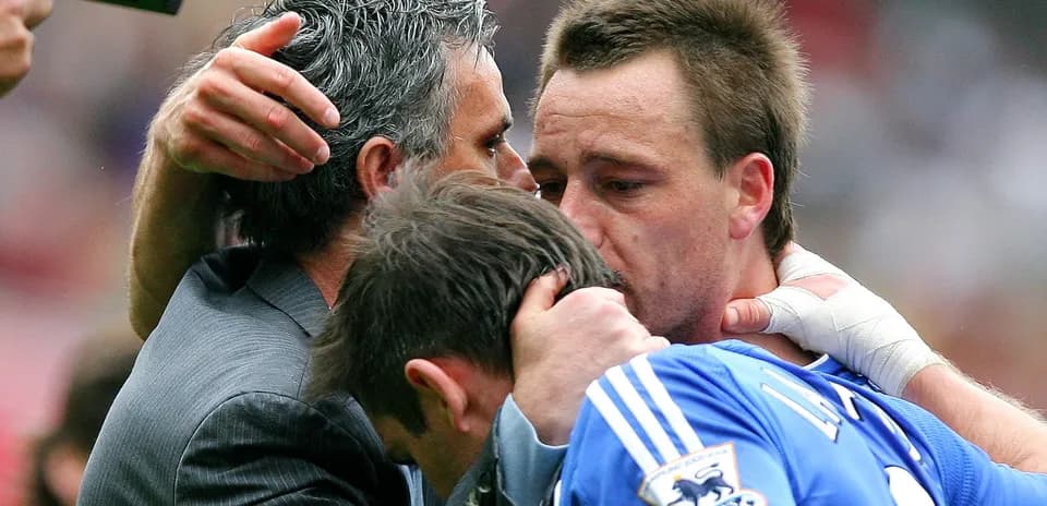 Players embracing after a match with a coach