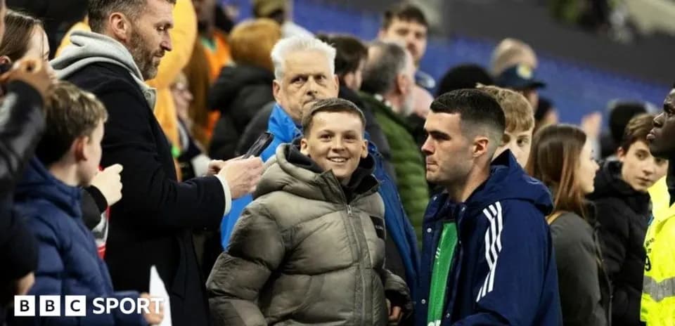 Fans interacting near the sidelines after a match