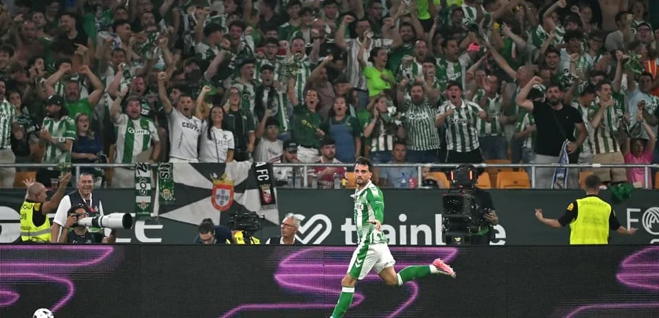 Player celebrating a goal in front of cheering fans