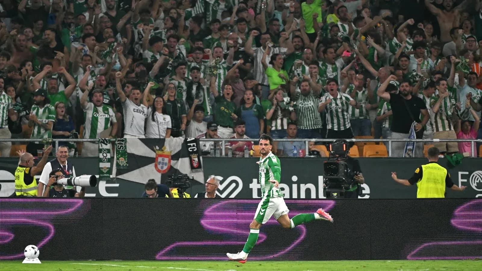 Player celebrating a goal in front of cheering fans