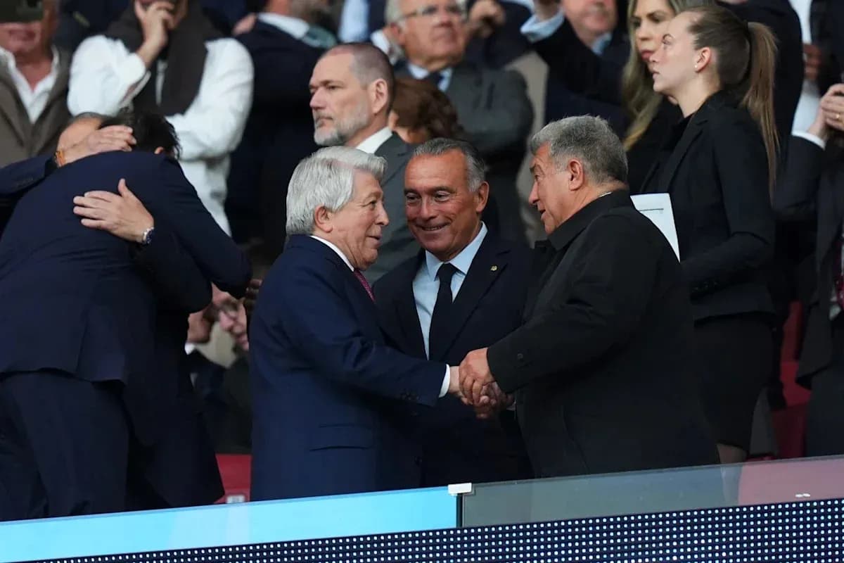 Three individuals shaking hands in a stadium box