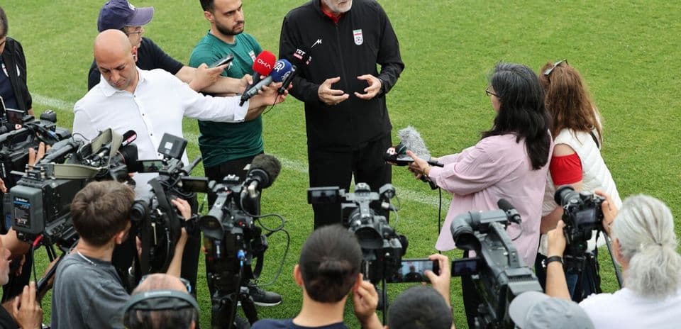 Coach speaking to media during press conference