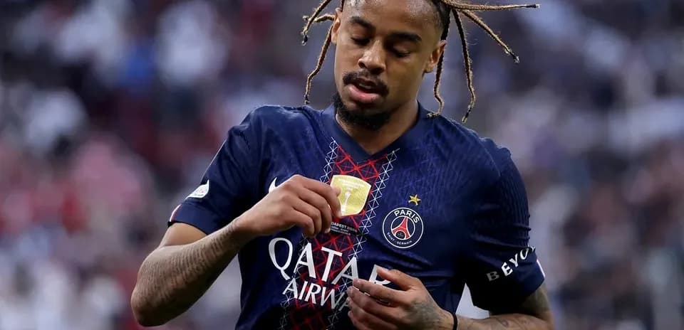 Player adjusting jersey with trophy emblem after match