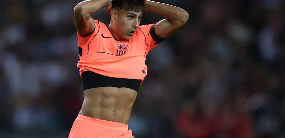 Player adjusting jersey during match in bright kit