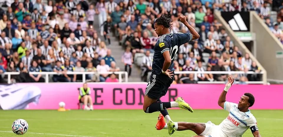 Player leaping over opponent during soccer match