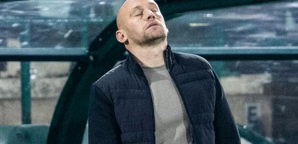 Coach looking up in frustration on the sidelines