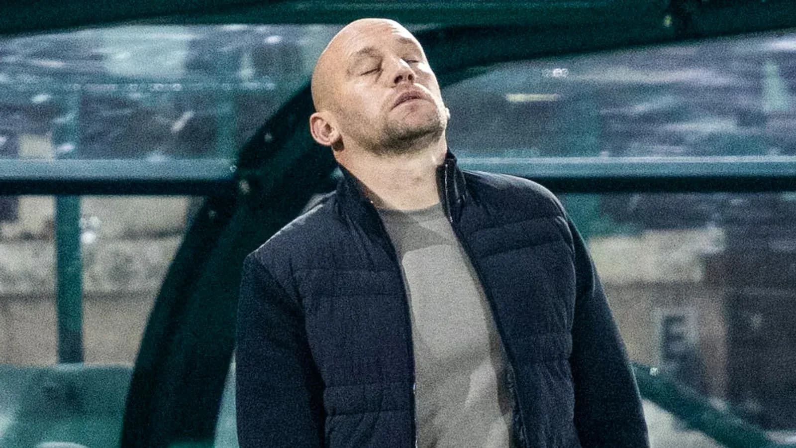 Coach looking up in frustration on the sidelines