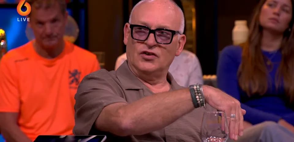 Man gesturing during a talk show discussion