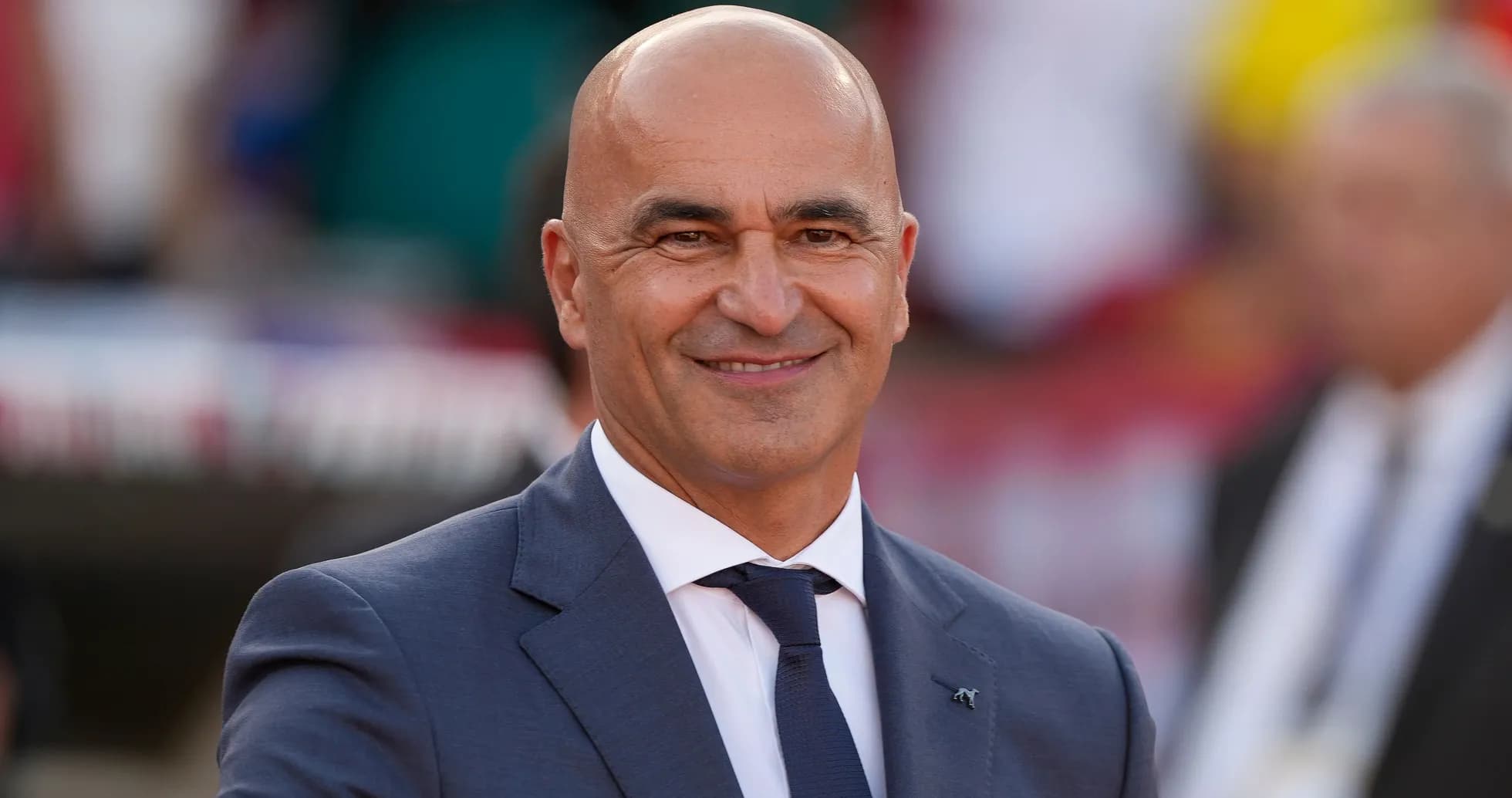 Smiling coach in a suit during event