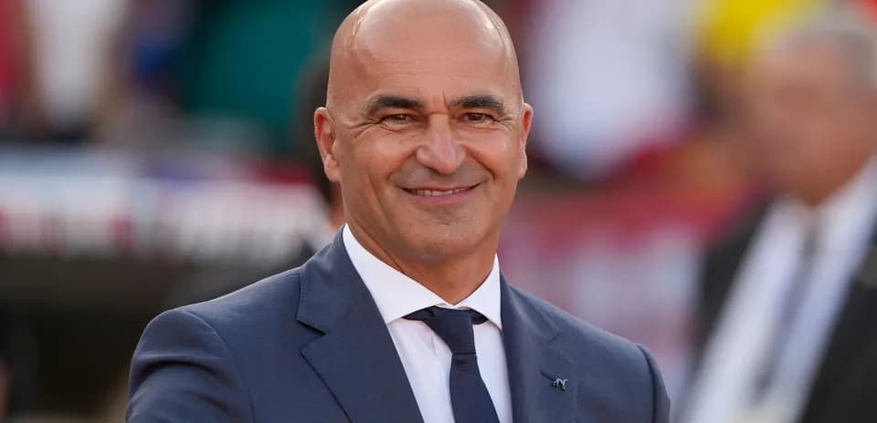 Smiling coach in a suit during event