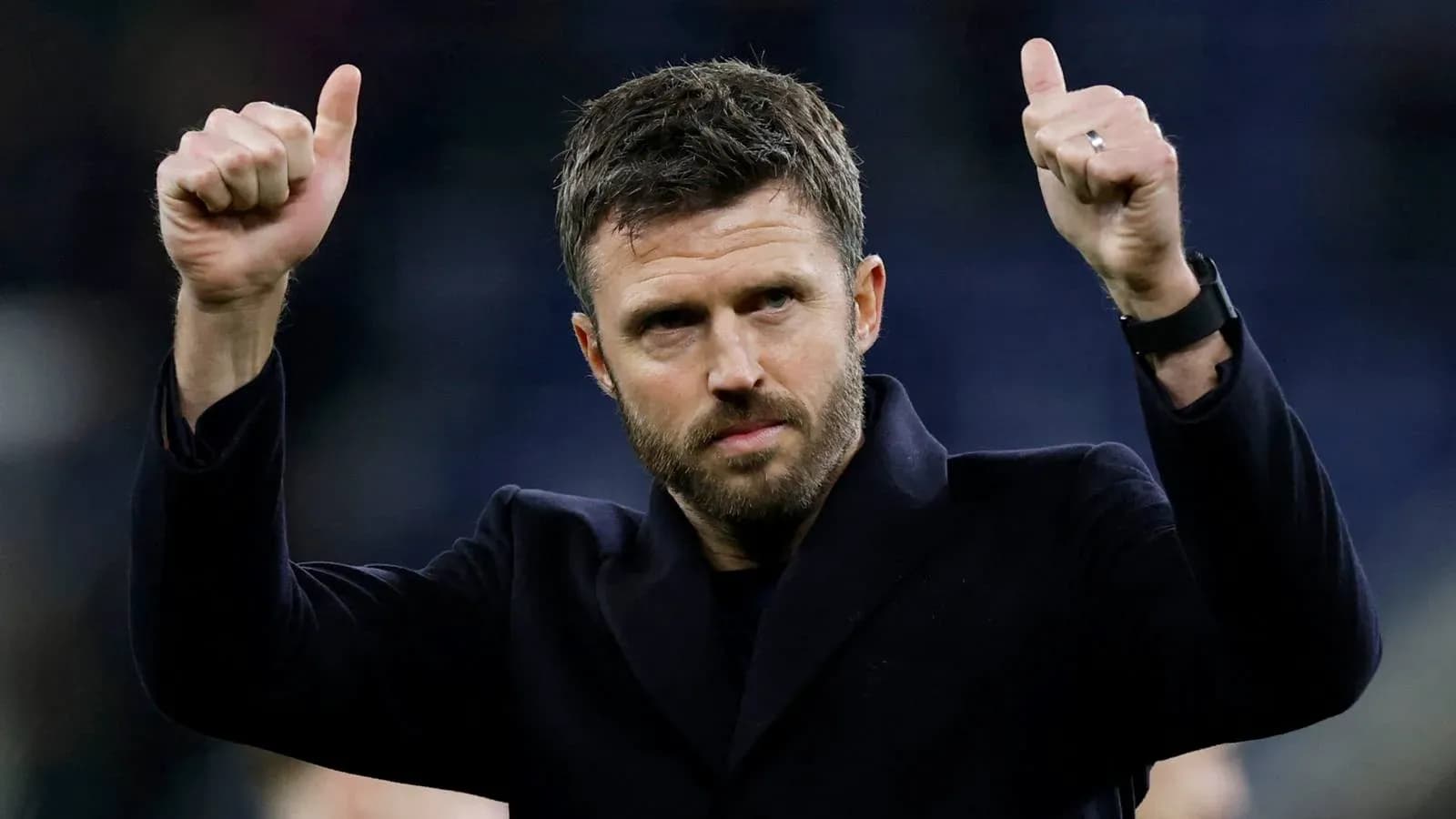 Coach gesturing with thumbs up after match