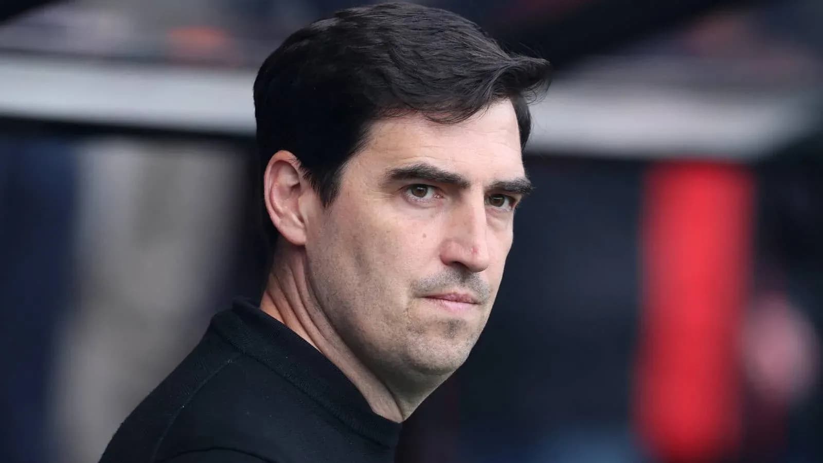 Coach observing from the sidelines during a match