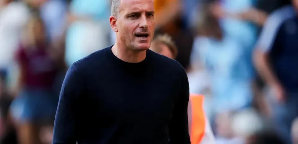 Coach giving instructions on the sidelines during match