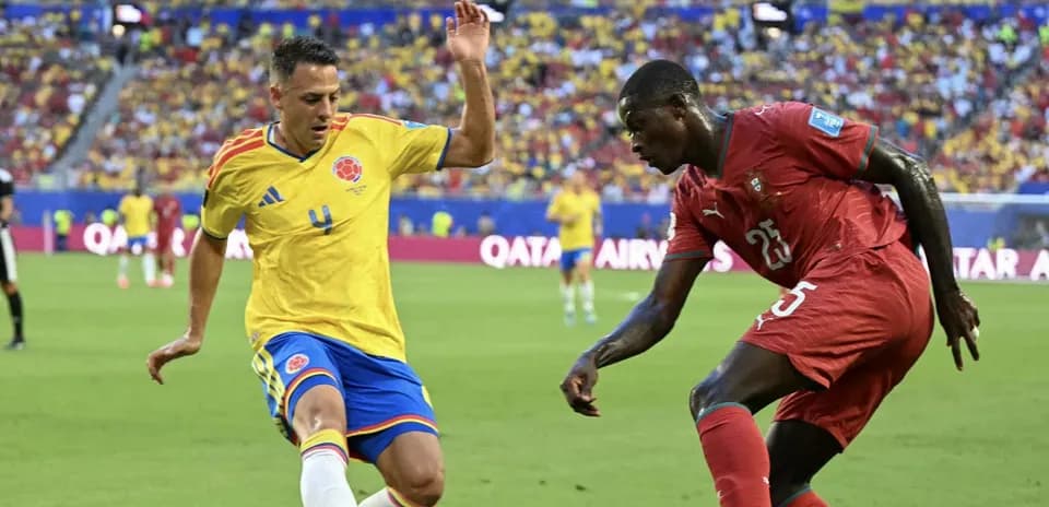 Colombian player defending against Moroccan opponent during match