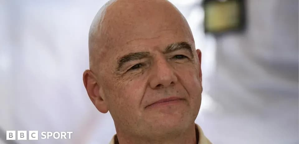 Man with bald head and light shirt outdoors
