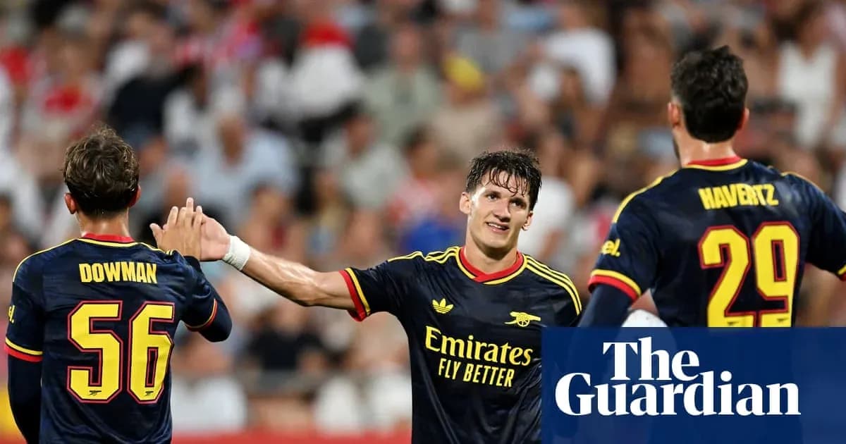 Three Arsenal players celebrating during a match